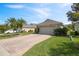 Attractive home featuring a spacious driveway and beautiful landscaping at 3905 Osprey Pointe Cir, Winter Haven, FL 33884