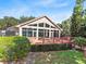 View of the lakefront building featuring a large patio area and lush foliage at 3905 Osprey Pointe Cir, Winter Haven, FL 33884