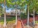 View of the lakefront building featuring a large patio area and lush foliage at 3905 Osprey Pointe Cir, Winter Haven, FL 33884