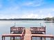 Picturesque view of a tranquil lake from dock with seating area at 3905 Osprey Pointe Cir, Winter Haven, FL 33884