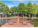 Lakefront dock featuring benches and walking ramp surrounded by trees at 3905 Osprey Pointe Cir, Winter Haven, FL 33884