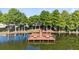 Scenic lakefront dock featuring benches and walking ramp surrounded by trees at 3905 Osprey Pointe Cir, Winter Haven, FL 33884