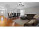 Open-concept living room features hardwood floors, high ceilings, and lots of natural light at 3905 Osprey Pointe Cir, Winter Haven, FL 33884