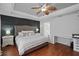 Main bedroom features hardwood floors, decorative ceiling fan, and custom headboard at 3905 Osprey Pointe Cir, Winter Haven, FL 33884