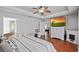 Main bedroom features hardwood floors, decorative ceiling fan, and ensuite bathroom at 3905 Osprey Pointe Cir, Winter Haven, FL 33884