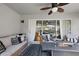 Relaxing covered patio featuring comfortable seating, ceiling fan, and a cozy fire pit table, with sliding glass doors to the interior at 3905 Osprey Pointe Cir, Winter Haven, FL 33884