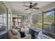 Screened-in porch with wicker furniture, fire pit table, ceiling fan, and views of the backyard at 3905 Osprey Pointe Cir, Winter Haven, FL 33884