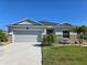 Charming single-story home with a well-manicured lawn and a two-car garage, plus stone accents at 398 Quarry Rock Cir, Kissimmee, FL 34758