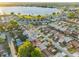 An expansive aerial shot reveals a community near a large lake, showcasing numerous homes and lush green spaces at 4016 Cypress S Lndg, Winter Haven, FL 33884
