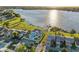 Scenic aerial view of community amenities including a pool, clubhouse, and lake access with an expansive waterfront at 4016 Cypress S Lndg, Winter Haven, FL 33884