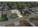 Charming home aerial view shows a well-manicured lawn, double car driveway and community street at 4016 Cypress S Lndg, Winter Haven, FL 33884
