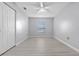 Bedroom featuring light gray walls, light-colored flooring, a ceiling fan, and a window with blinds at 4016 Cypress S Lndg, Winter Haven, FL 33884