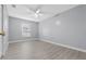 Bedroom featuring light gray walls, light-colored flooring, a ceiling fan, and a window with blinds at 4016 Cypress S Lndg, Winter Haven, FL 33884