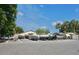 Boat storage area with multiple covered boats on trailers, with parking and palm trees in the background at 4016 Cypress S Lndg, Winter Haven, FL 33884