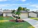 Charming single-story home featuring a well-manicured lawn and a two-car garage on a sunny day at 4016 Cypress S Lndg, Winter Haven, FL 33884