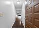 Inviting hallway with dark hardwood floors leading to a bright living area, showcasing the home's open layout at 4016 Cypress S Lndg, Winter Haven, FL 33884