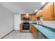 Kitchen with stainless steel appliances, wood cabinets, and modern tile floor at 4016 Cypress S Lndg, Winter Haven, FL 33884