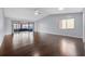 Spacious living room featuring beautiful dark hardwood floors, vaulted ceilings, and sliding glass doors to the patio at 4016 Cypress S Lndg, Winter Haven, FL 33884