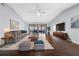 Stylish living room featuring modern furnishings, a cozy rug, and sliding doors leading to an enclosed patio at 4016 Cypress S Lndg, Winter Haven, FL 33884