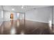 Open living room with hardwood floors and ceiling fan, offering ample space for relaxation and entertaining at 4016 Cypress S Lndg, Winter Haven, FL 33884