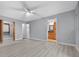 Main bedroom with light gray walls and wood-look floors leading to ensuite bath at 4016 Cypress S Lndg, Winter Haven, FL 33884