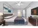 Main bedroom featuring neutral colors, large bed, and ensuite bath at 4016 Cypress S Lndg, Winter Haven, FL 33884