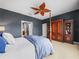 The main bedroom includes a decorative ceiling fan, dark gray walls and a large wardrobe at 4088 Dunmore Dr, Lake Wales, FL 33859