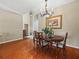 Cozy dining room with hardwood floors, chandelier, and natural light at 4088 Dunmore Dr, Lake Wales, FL 33859