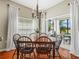 Dining area with hardwood floors, elegant chandelier, and natural light from the sliding glass door at 4088 Dunmore Dr, Lake Wales, FL 33859