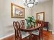 Elegant dining room with a chandelier, hardwood floors, and tasteful decor at 4088 Dunmore Dr, Lake Wales, FL 33859
