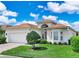 Charming single-story home with manicured lawn, brick driveway, and a two-car garage at 4088 Dunmore Dr, Lake Wales, FL 33859