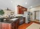 Kitchen featuring a granite island, stainless steel appliances, and dark wood cabinets, open to living area at 4088 Dunmore Dr, Lake Wales, FL 33859