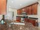 A kitchen view showcasing rich granite countertops and dark wood cabinetry with stainless steel appliances at 4088 Dunmore Dr, Lake Wales, FL 33859