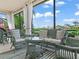 Relaxing lanai featuring wicker furniture, a striped rug and golf course views at 4088 Dunmore Dr, Lake Wales, FL 33859