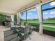 Relaxing lanai featuring wicker furniture, tile flooring and golf course views at 4088 Dunmore Dr, Lake Wales, FL 33859