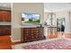 Open-concept living area with hardwood floors, media center, and an inviting floor rug at 4088 Dunmore Dr, Lake Wales, FL 33859