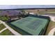 Aerial view of well-maintained tennis courts next to a large clubhouse and lake at 4088 Dunmore Dr, Lake Wales, FL 33859
