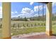 A backyard and view of surrounding properties and distant trees at 438 Monroe Cir, Davenport, FL 33896