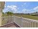 Balcony view overlooking lush green field and neighborhood homes on a sunny day at 438 Monroe Cir, Davenport, FL 33896