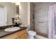 Bathroom showcasing tiled shower with glass door, vanity, toilet, and decorative accents at 438 Monroe Cir, Davenport, FL 33896