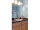 Bathroom features a vanity with a dark countertop, stylish mirror, and accent decorations at 438 Monroe Cir, Davenport, FL 33896