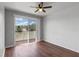 Spacious bedroom with hardwood floors and a sliding glass door to the outdoor balcony at 438 Monroe Cir, Davenport, FL 33896