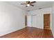 Bedroom features hardwood floors, a ceiling fan, closet, and a bathroom with a tiled shower at 438 Monroe Cir, Davenport, FL 33896