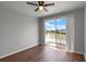 Bedroom with hardwood floors, a ceiling fan, and a sliding door leading to a balcony at 438 Monroe Cir, Davenport, FL 33896