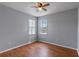 Neutral bedroom featuring wood laminate flooring and two windows for natural light at 438 Monroe Cir, Davenport, FL 33896
