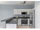 Well-equipped kitchen with white cabinetry, stainless steel appliances, and stylish backsplash at 438 Monroe Cir, Davenport, FL 33896