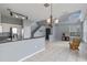 Open-concept living area with tile floors, gray walls, modern lighting, and staircase access at 438 Monroe Cir, Davenport, FL 33896