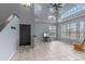 Inviting living room with soaring ceilings, large windows, tile flooring, and a cozy rocking chair at 438 Monroe Cir, Davenport, FL 33896