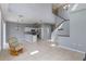 Open-concept living space featuring tile flooring, staircase, and a kitchen with stainless steel appliances at 438 Monroe Cir, Davenport, FL 33896