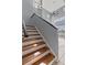 Staircase leading to the second floor with hardwood steps and a large window illuminating the area at 438 Monroe Cir, Davenport, FL 33896